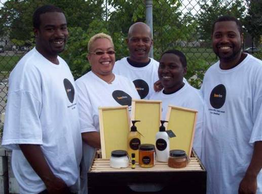 Sweet Beginnings team members pose with some of the products the apiary produces. Photo Courtesy Sweet Beginnings. 
